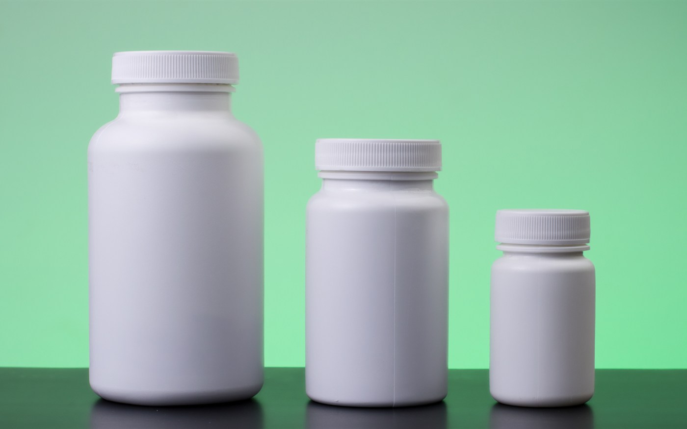 White supplement bottles in three sizes ready for private-label packing