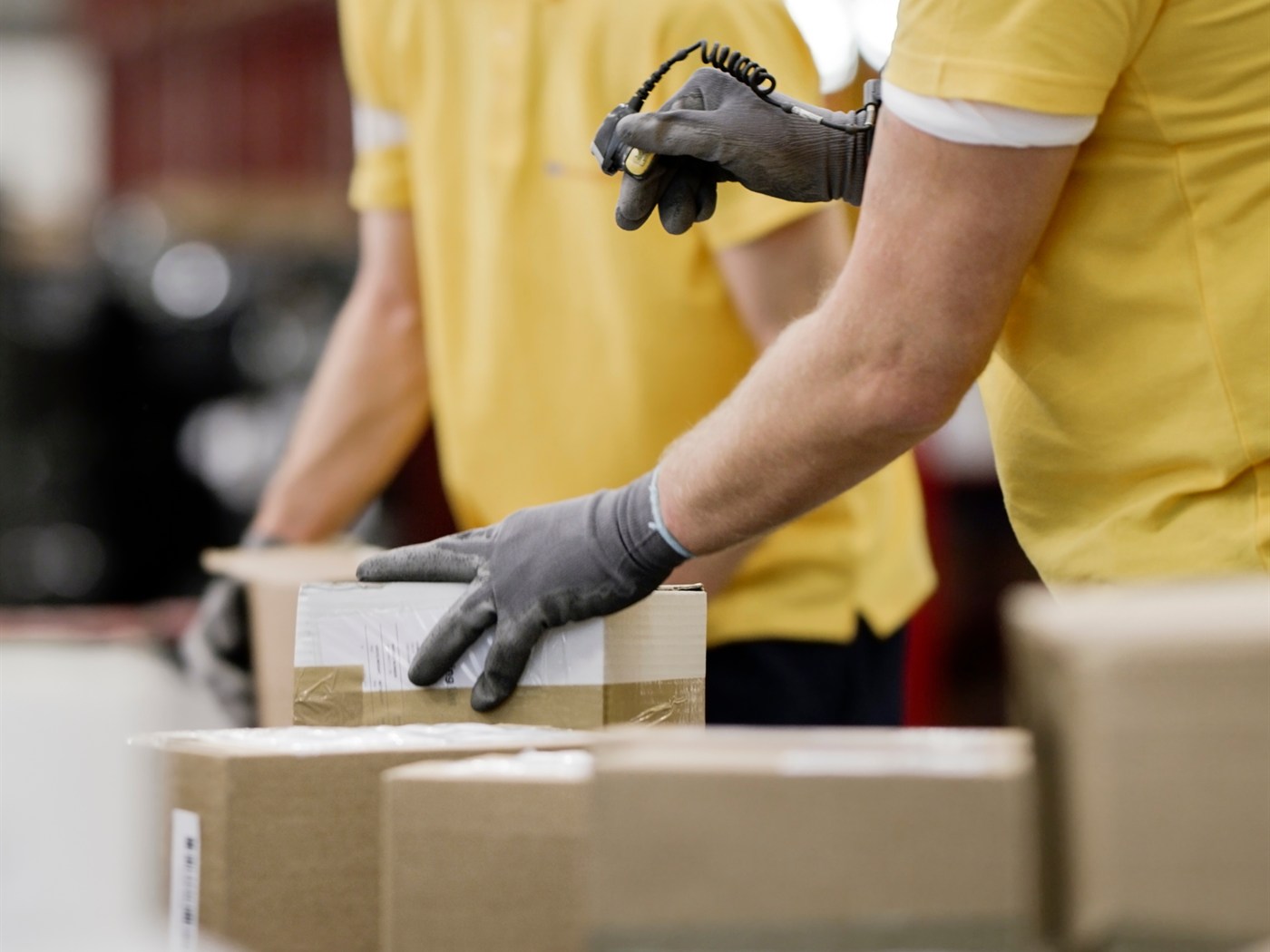 Box It team scanning and packing customer orders on the warehouse floor